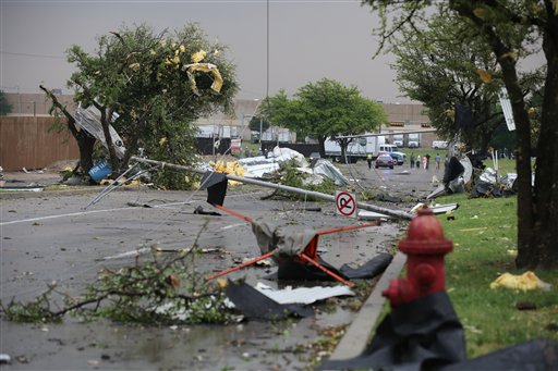A pole and branches are scattered on the ground after a storm passed through Arlington, Texas, today.