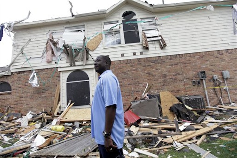 Charles Paige stands amongst tornado debris as he surveys the damage to his home Wednesday, April 4, 2012, in Forney, Texas. The mayor of Forney, Texas, says it's "a real blessing" that nobody was killed in the community by the tornadoes that ripped through parts of the Dallas area yesterday (AP Photo/Tony Gutierrez)
