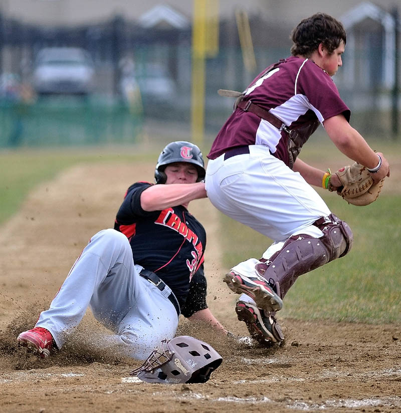 Thomas College's Rob Nutter, 35, unsuccessfully slides in to home plate to beat the force play by University of Maine at Farmington cathcer Matthew Woodbury, 8, in the second game of a double-header at Thomas College in Waterville Wednesday.