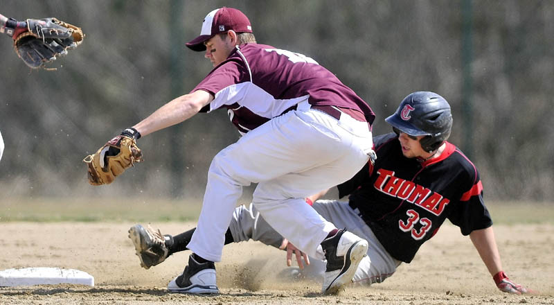HUSTLE BACK: UMF shortstop Brett Wallingford, left, reaches back to tag second base as Thomas’ Taylor Livingston tries to beat the play Wednesday in Waterville.