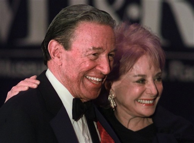 In this Feb. 4, 1999 file photo, Barbara Walters and Mike Wallace pose for photographers before the start of a gala for The Museum of Television and Radio in New York. Wallace, the dogged, merciless reporter and interviewer who took on politicians, celebrities and other public figures in a 60-year career highlighted by the on-air confrontations that helped make "60 Minutes" the most successful primetime television news program ever, has died. He was 93. (AP Photo/Mark Lennihan)