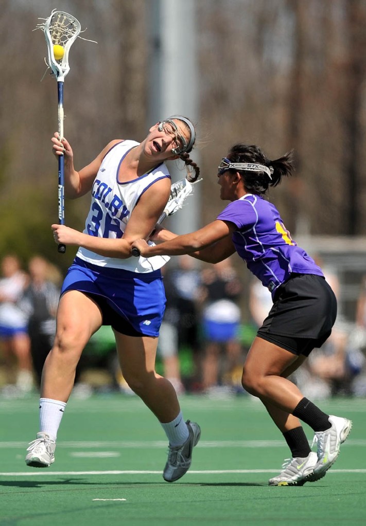Staff Photo by Michael G. Seamans Colby College's Katie Griffin, 36,left, battles with Williams College defender, Meera Sivalingam, 10, in the first period at Colby College in Waterville on Saturday.