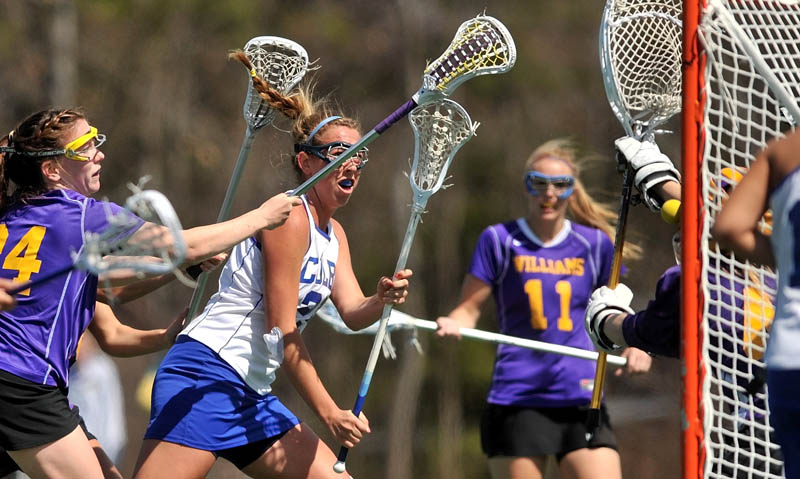 Staff Photo by Michael G. Seamans Colby College's Lindsey McKenna, 25, center left, takes a shot on Williams College goalie, Ali Pitch, 46, in the first period at Colby College in Waterville on Saturday.
