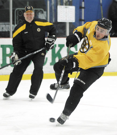 SHOOT IT: Boston Bruins head coach Claude Julien watches as forward Brad Marchand shoots the puck during team practice Monday in Wilmington, Mass. The Bruins face the Washington Capitals in Game 1 of their playoff series Thursday.