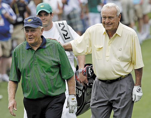 HEY OLD FRIEND: Jack Nicklaus, left, walks with Arnold Palmer on the second hole during the par 3 competition at the Masters golf tournament Wednesday in Augusta, Ga.
