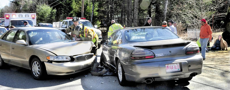 CRASH SCENE: Accident victim Julia Salsbury of Fairfield, right, is treated for injuries after her vehicle and another car driven by Lorraine Blaisdell, at left, collided on the Greene Road in Fairfield Center on Tuesday. Blaisdell may have suffered a medical condition prior to the accident, according to police.