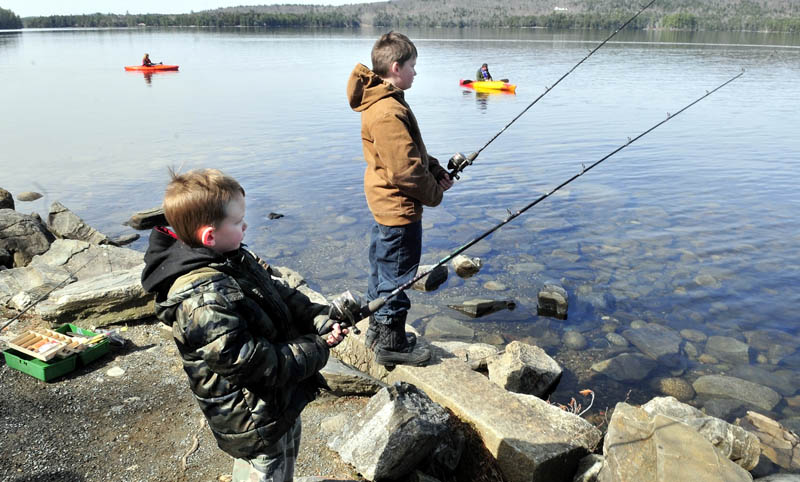 OPEN SEASON: Fishermen including Adden Ricci, left, and his brother Shane of Hartland and kayakers fished on Long Lake in Belgrade on Sunday.