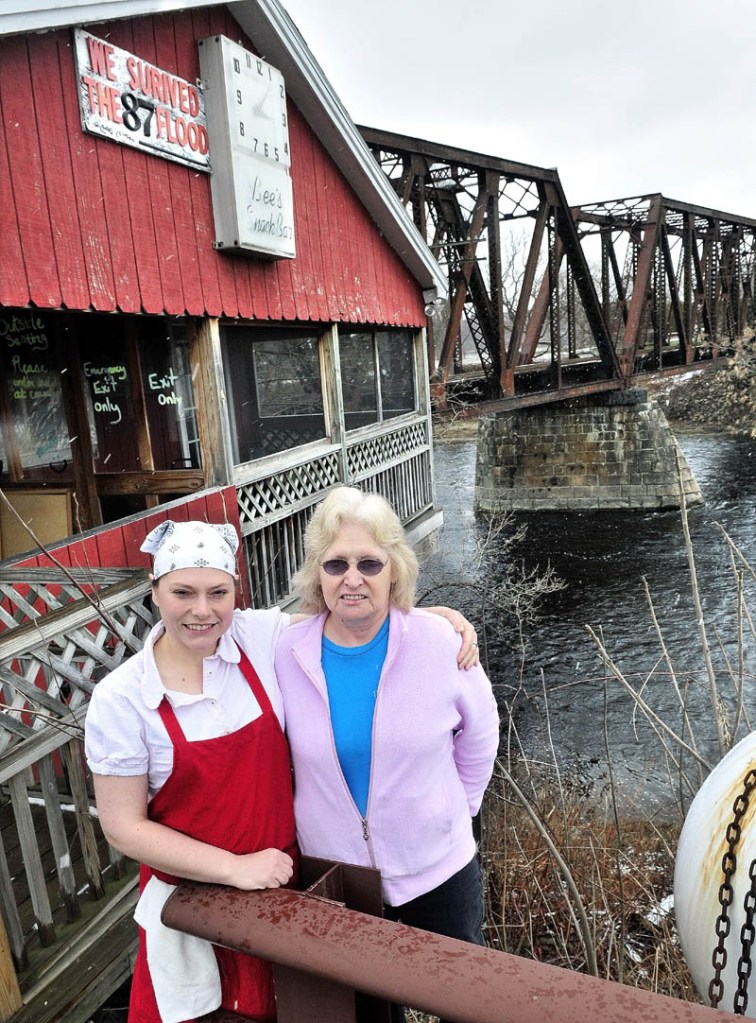 CLOSE CALL: Ryan Willette, left, and her mother Evelyn Willette stand outside their restaurant Bee's Snack Bar beside the Sebasticook River in Winslow recently. The business narrowly escaped being swept away during the flood of 1987.