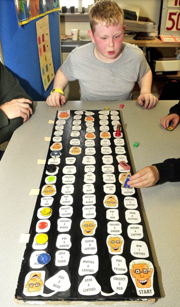 MATH SKILLS: Cascade Brook School student Glenn Lumbert ponders his next move while playing a math skills game titled Smiling Sam the Game at the Farmington school.