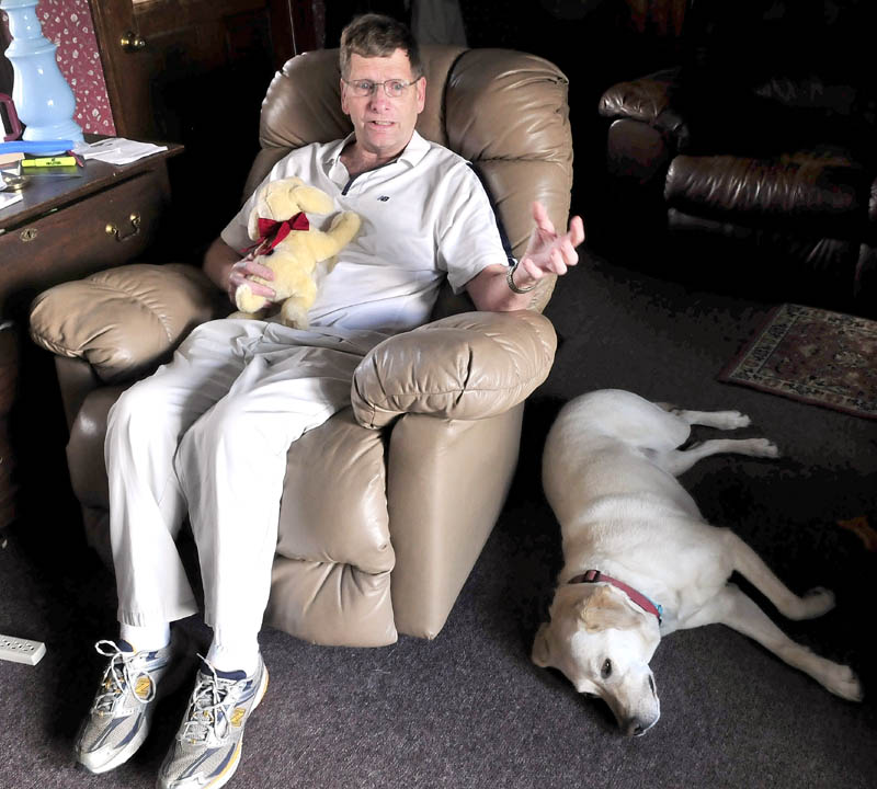 COMFORT: Karl Andresen of Winslow holds a stuffed dog in the likeness of his real dog Ruby given to him by his son Matthew while he was in the hospital after a crash March 18 in Waterville. Andresen said the toy gave him comfort for his mending broken ribs and assurance that he is cared for by others.