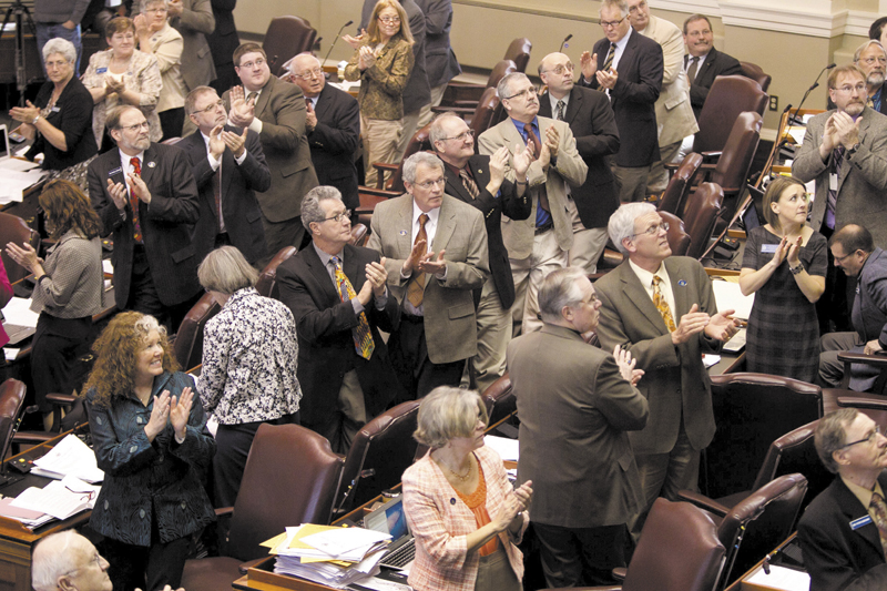 Legislators on the Republican side of the aisle stand and applaud visitors last week in the House Chamber. From cutbacks in MaineCare to slashed income taxes, Gov. Paul LePage and Maine’s Republican-majority Legislature have left their mark.