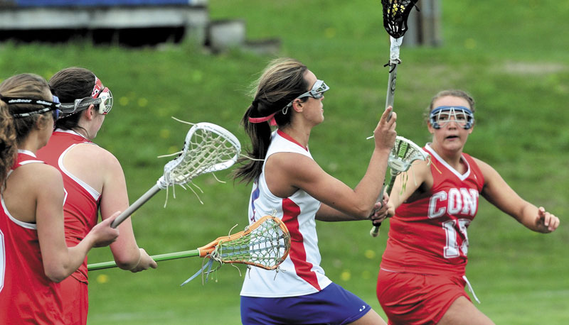ON THE MOVE: Messalonskee’s Kristyna Bernatchez weaves through Cony players, including Kevie Rodrique, right, during the Rams’ 11-10 win Thursday in Oakland.