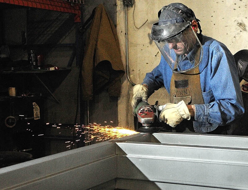 Donny Morin grinds smooth a welded joint on a door frame he is building recently at J/R Metal Frame in Belgrade. The company is building door and window frames for the new MaineGeneral regional hospital being built in Augusta.