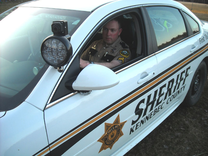 WATCHING: Cpl. Scott Mills of the Kennebec County Sheriff’s Office is seen in his cruiser with the thermal imaging camera mounted near the window.