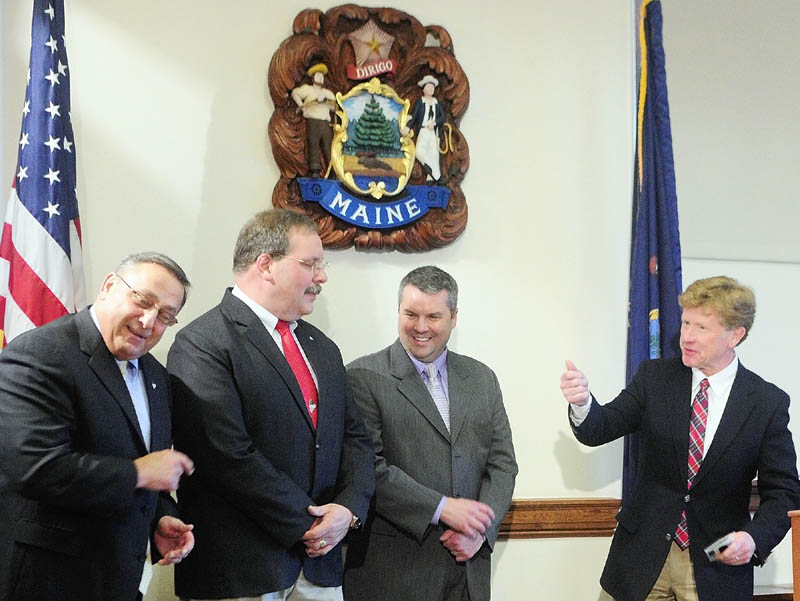 During a bill signing ceremony Tuesday, Gov. Paul LePage, far left, and Sen. Bill Diamond, D-Cumberland, far right, talk about different things they’ve seen distracted drivers doing such as putting on make up. Rep. Richard Cebra, R-Naples, next to LePage, and Sen. Jon Courtney, R-Springvale, also attended the signing in the Cabinet Room at the State House. LePage signed the bill, L.D. 1912, “An Act To Encourage Responsible Teen Driving,” is a response to the high number of teen fatalities in Maine during the past four months.