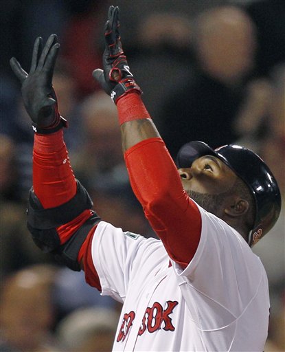 Boston Red Sox designated hitter David Ortiz gestures as he crosses home plate on his solo home run, his second of the game, during the fifth inning of a baseball game against the Oakland Athletics at Fenway Park in Boston, Monday, April 30, 2012. (AP Photo/Charles Krupa)