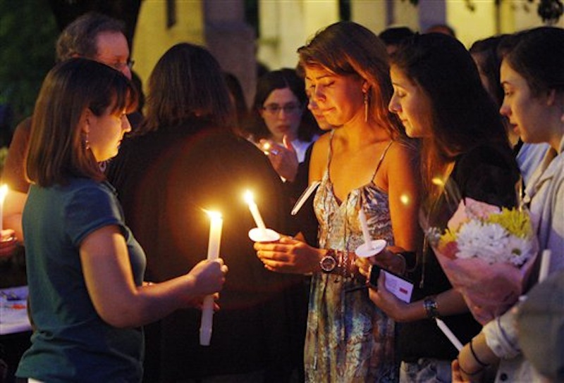 Boston University students including Tori Pinheiro, third right, of New Bedford, Mass., and Austin Brashears' girlfriend, holds a candlelight vigil on Marsh Plaza at Boston University, Saturday, May 12, 2012, in Boston, for three students studying in New Zealand who were killed when their minivan crashed during a weekend trip. Daniela Lekhno, 20, of Manalapan, N.J.; Austin Brashears, 21, of Huntington Beach, Calif.; and Roch Jauberty, 21, whose parents live in Paris, were killed as they traveled in a minivan Saturday near the North Island vacation town of Taupo when the vehicle drifted to the side of the road and then rolled when the driver tried to correct course. (AP Photo/Bizuayehu Tesfaye)