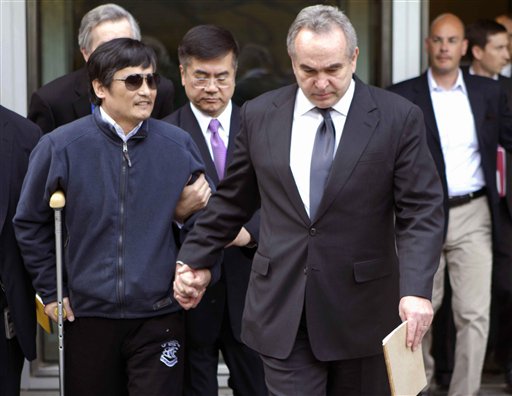 In this photo released by the US Embassy in Beijing, blind lawyer Chen Guangcheng, left, is helped by U.S. Assistant Secretary of State for East Asia and Pacific Affairs Kurt Campbell, right, and U.S. Ambassador to China Gary Locke as they leave the U.S. Embassy for a hospital in Beijing on Wednesday.