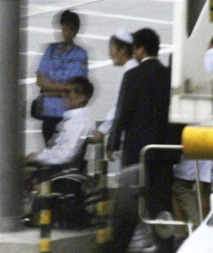 Chinese activist Chen Guangcheng, in a wheelchair, is helped to head to a commercial flight Saturday, May 19, 2012 at Beijing International Airport in Beijing. Chen was hurriedly taken from a hospital Saturday and boarded a plane that took off for the United States, closing a nearly monthlong diplomatic tussle that had tested U.S.-China relations. (AP Photo/Kyodo News) JAPAN OUT, MANDATORY CREDIT, NO LICENSING IN CHINA, HONG KONG, JAPAN, SOUTH KOREA AND FRANCE