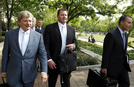 Former Major League Baseball pitcher Roger Clemens, center, leaves federal court on Tuesday in Washington.