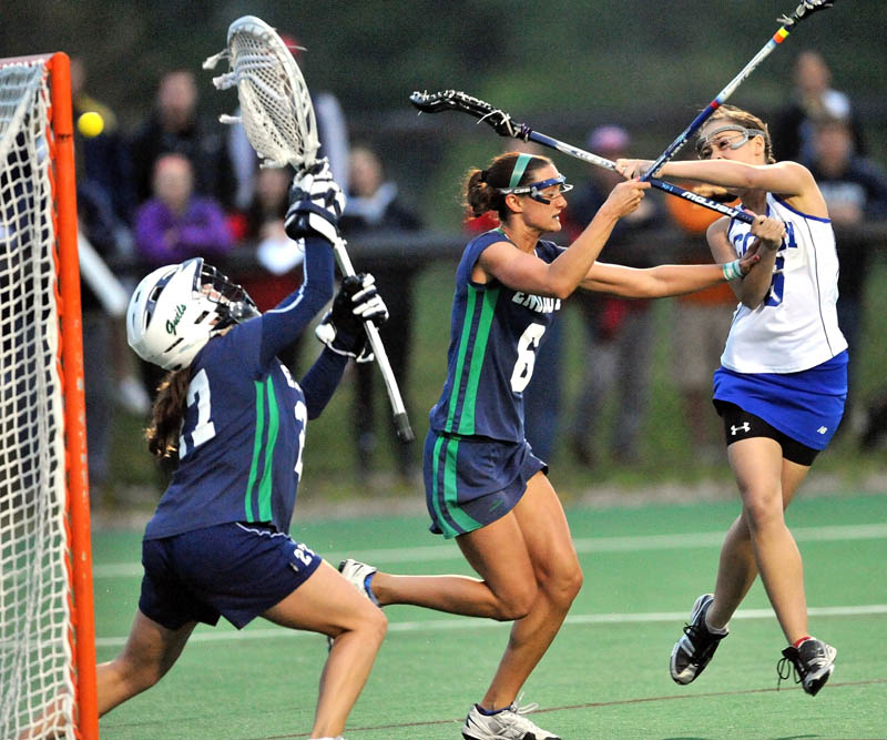 GOAL: Colby’s Alex Mintz, right, scores on Endicott College defender Stacia Geno, center, and goalie Leah Neff in the first round of the NCAA Division III women’s lacrosse tournament Wednesday at Colby College in Waterville.