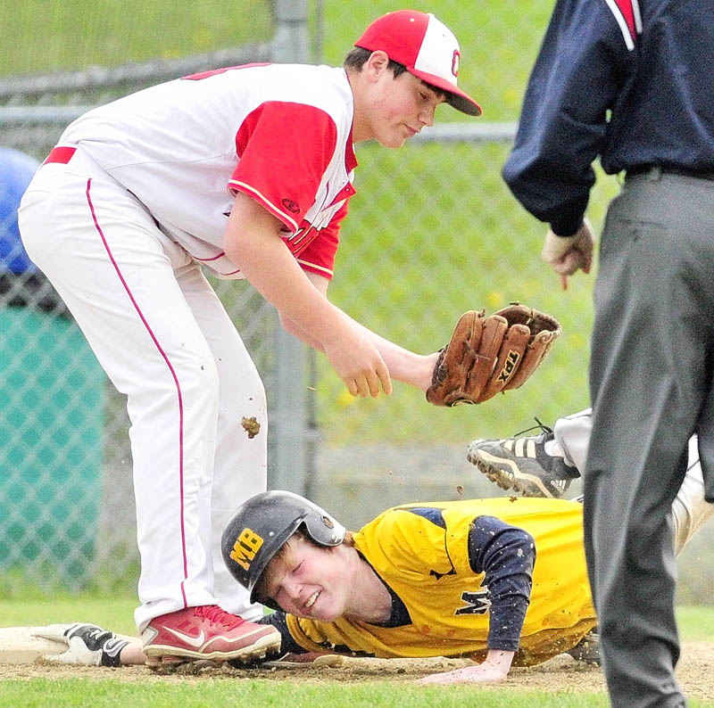 NOT QUITE: Cony third baseman Mitch Caron stands over Mt. Blue baserunner Charlie Martin after Martin was tagged out at third in rundown during the Cougars’ 1-0 loss on Friday evening in Augusta.