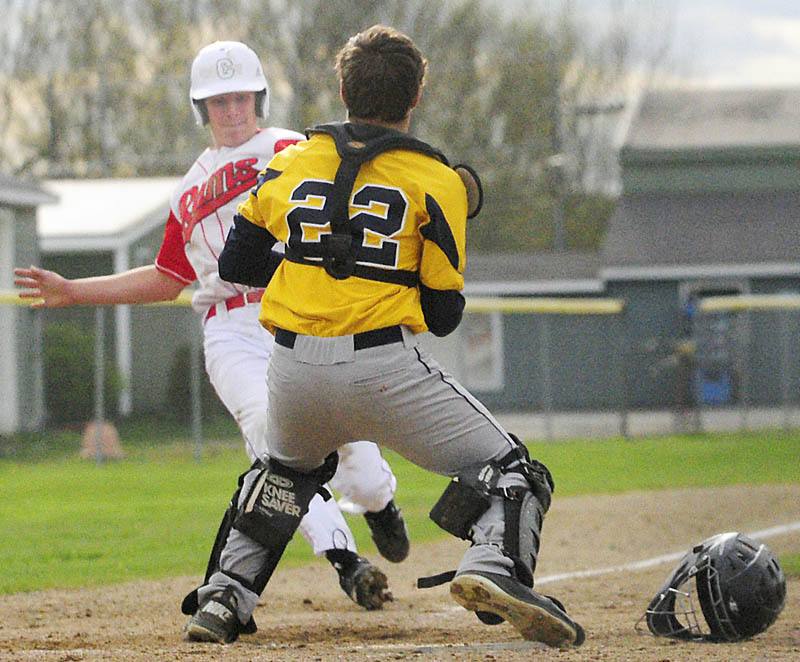 YER OUT: Cony baserunner Charlie Hallack can’t beat the throw and is about to be tagged out at home by Mt. Blue catcher Andrew Pratt during the Ram’s 1-0 win on Friday in Augusta.
