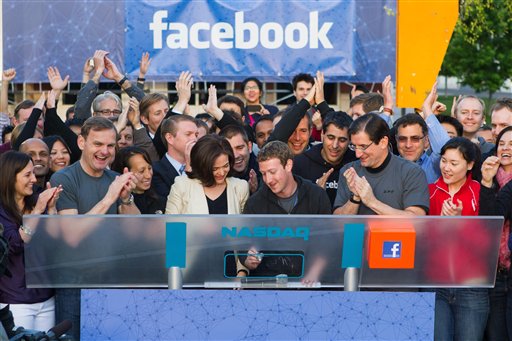 Facebook founder, Chairman and CEO Mark Zuckerberg, center, remotely rings the opening bell of the Nasdaq stock market today from Facebook headquarters in Menlo Park, Calif.