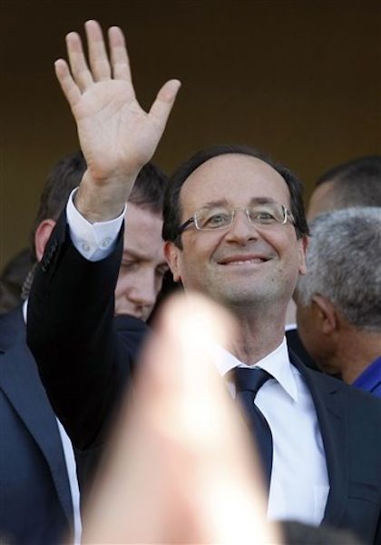 Socialist Party candidate for the presidential election Francois Hollande waves after visiting a polling station near Tulle, central France, Sunday, May 6, 2012. (AP Photo/Lionel Cironneau)
