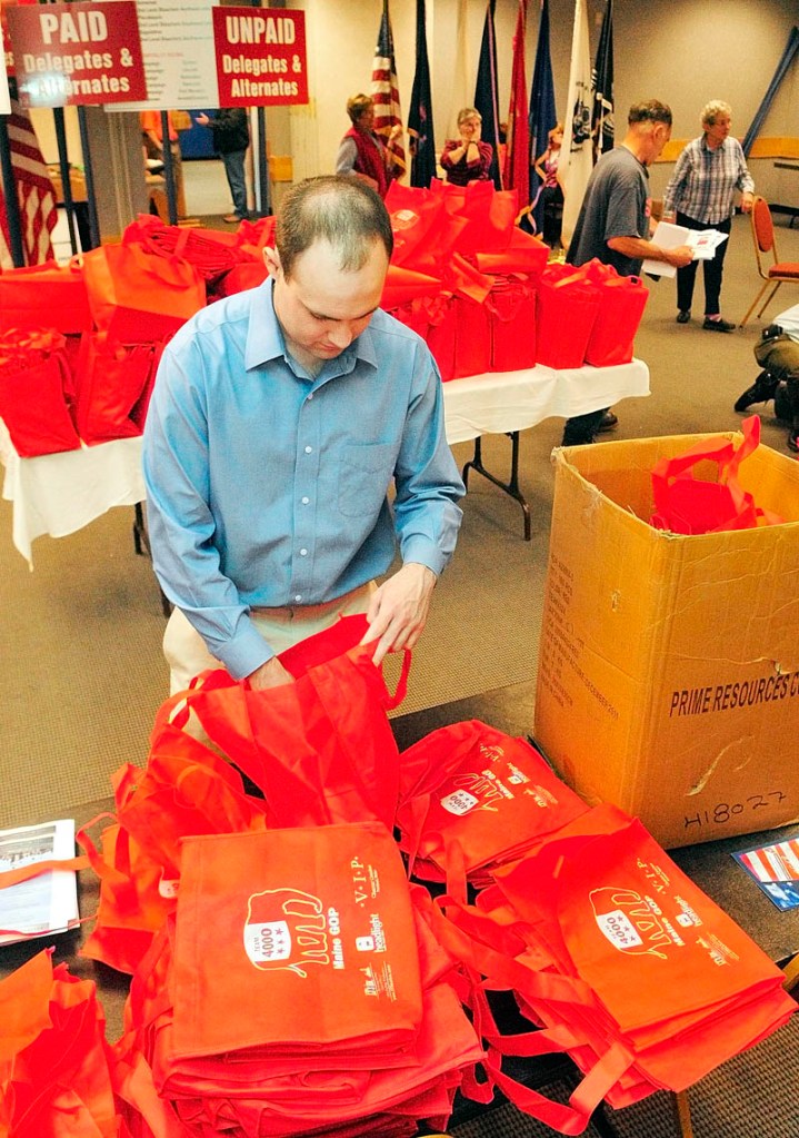John McMahon, a volunteer for the Mitt Romney campaign from New Hampshire, stuff leaflets into bags that will be given to Republican state party convention delegates and alternates on Friday afternoon at the Augusta Civic Center. The state Republican convention opens this morning and runs through Sunday.