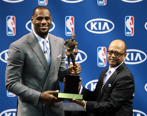 Miami Heat's LeBron James, left, poses with the NBA MVP trophy alongside Kia's Percy Vaughn, Saturday, May 12, 2012, in Miami. Calling the honor "overwhelming" but pointing to a "bigger goal," James on Saturday became the eighth player in NBA history to win the MVP award three times. (AP Photo/El Nuevo Herald, Roberto Koltun) MAGS OUT Heat13;HWW13 Heat News rk
