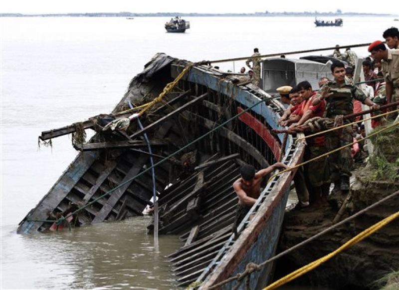 Rescuers pull out the wreckage of a ferry that capsized in the Brahmaputra River at Buraburi village, about 350 kilometers (215 miles) west of the state capital Gauhati, India, Tuesday, May 1, 2012. Army divers and rescue workers pulled more than 100 bodies out of a river after a packed ferry capsized in heavy winds and rain in remote northeast India, an official said Tuesday. At least 100 people were still missing Tuesday after the ferry carrying about 350 people broke into two pieces late Monday, said Pritam Saikia, the district magistrate of Goalpara district. (AP Photo/Anupam Nath)