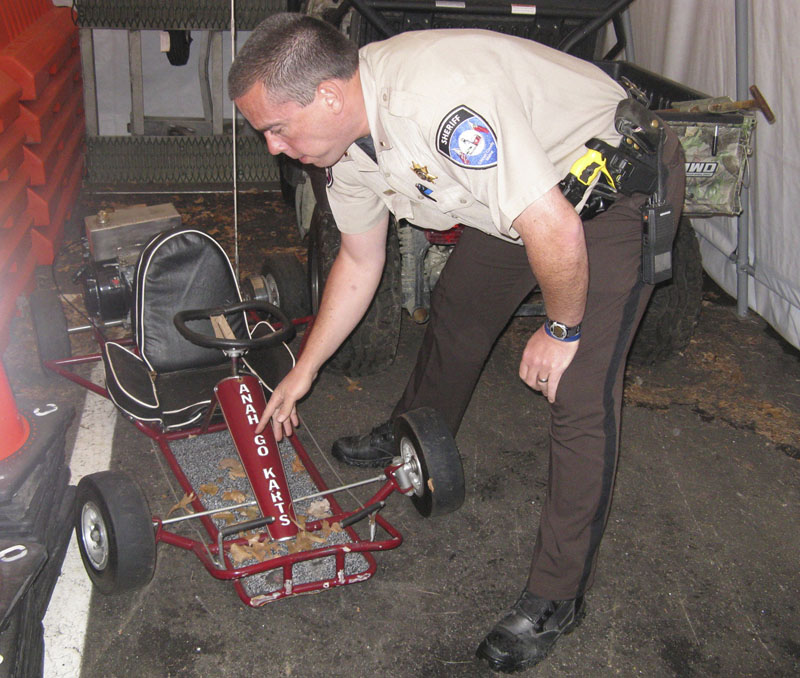 DAMAGED GO-CART: Lincoln County Sheriff’s Lt. Rand Maker points to frame damage on the go-cart that was driven by Marvin Tarbox, killed last year when his vehicle was in an accident while performing a stunt in the Damariscotta Pumpkinfest parade.