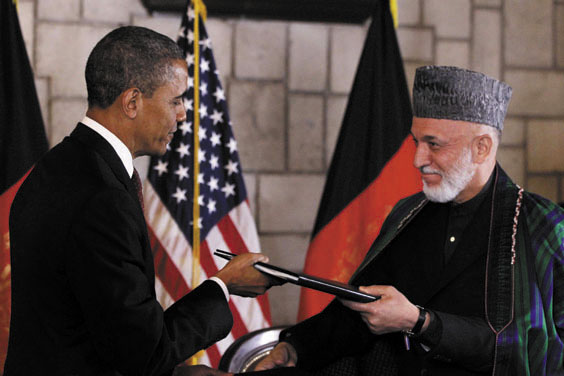DEAL: President Barack Obama and Afghan President Hamid Karzai sign an agreement Wednesday, setting postwar promises and expectations, at the presidential palace in Kabul.