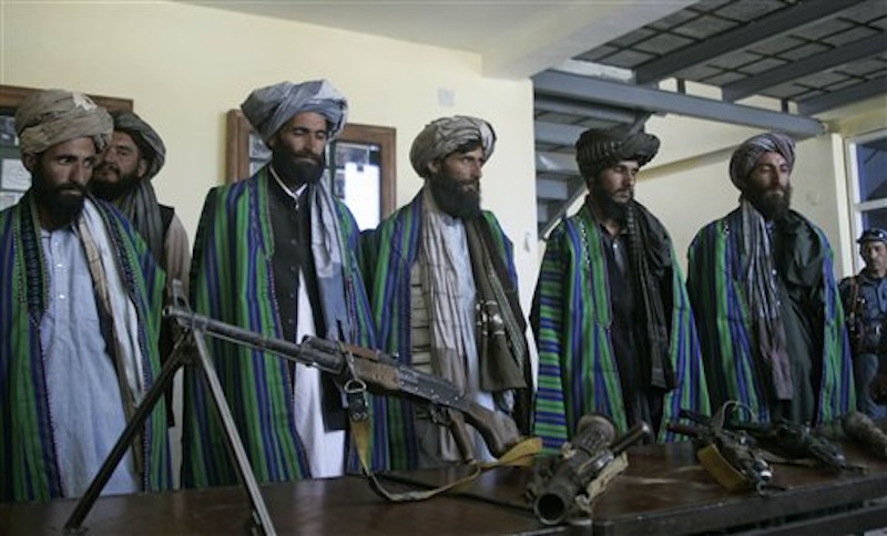 Former Taliban fighters hand over their weapons to Afghan police as part of a reconciliation process in Herat, Afghanistan, Sunday, May 13, 2012. As the U.S. and NATO prepare for the downsizing of international troops with a final withdrawal scheduled for 2014 efforts are underway to bring the Taliban off the battlefield. Taliban leaders including one of the most senior members of the organization, Agha Jan Motasim told The AP that most Taliban supported a negotiated end to the protracted war in Afghanistan. (AP Photo/Hoshang Hashimi)