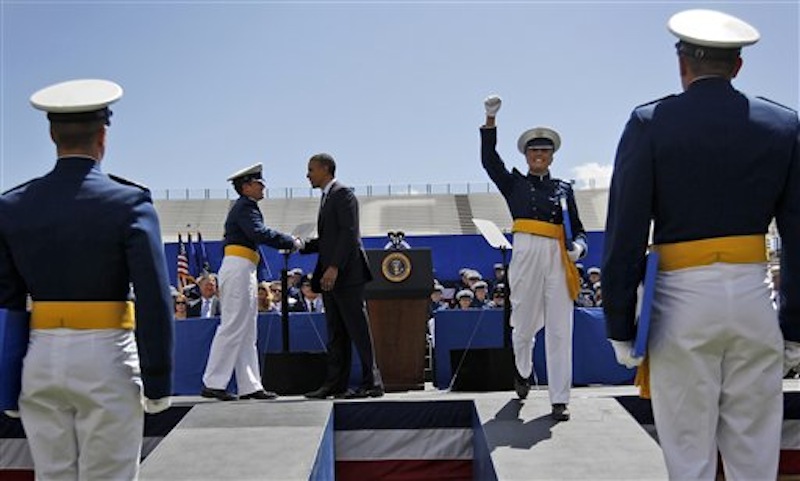 A cadet celebrates after being congratulated by President Barack Obama, center, during graduation ceremonies for the 2012 class of the U.S. Air Force Academy, Wednesday, May 23, 2012, in Colorado Springs, Colo. (AP Photo/Pablo Martinez Monsivais)