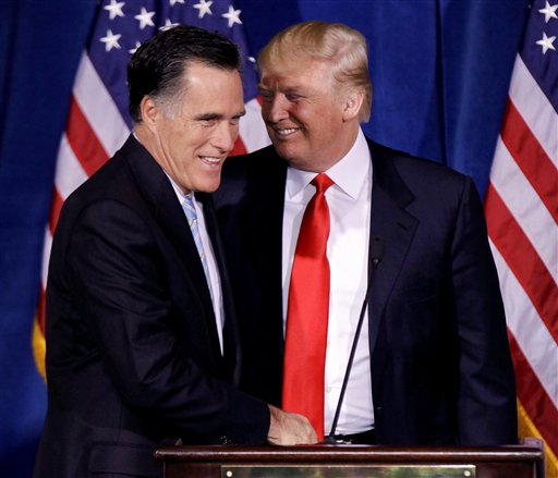 Donald Trump greets Republican presidential candidate Mitt Romney during a news conference in Las Vegas in this Feb. 2, 2012, photo.