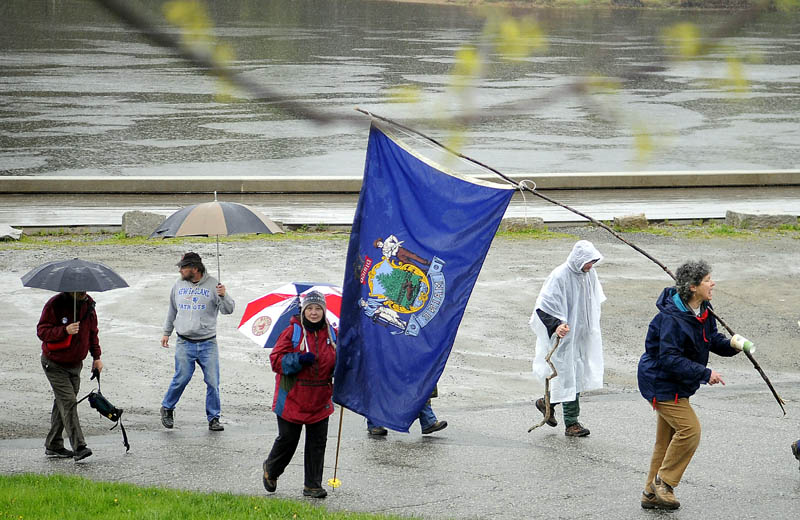 Marchers head out of the bulkhead Tuesday on the Kennebec River in Hallowell to Augusta raise awareness about environmental and economic issues.