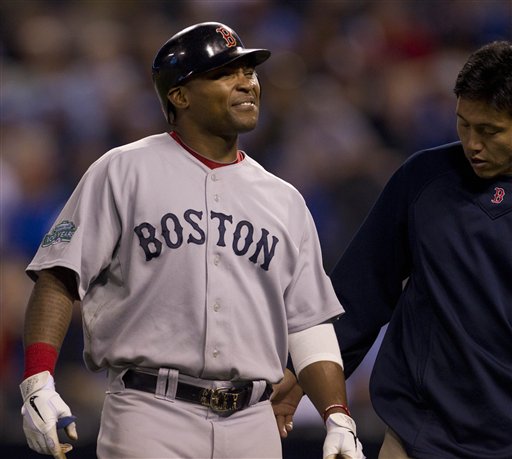 Boston Red Sox's Marlon Byrd, left, is checked by a trainer after trying to bunt during the ninth inning a baseball game against the Kansas City Royals in Kansas City, Mo., Wednesday, May 9, 2012. The Royals defeated the Red Sox 4-3. (AP Photo/Orlin Wagner)