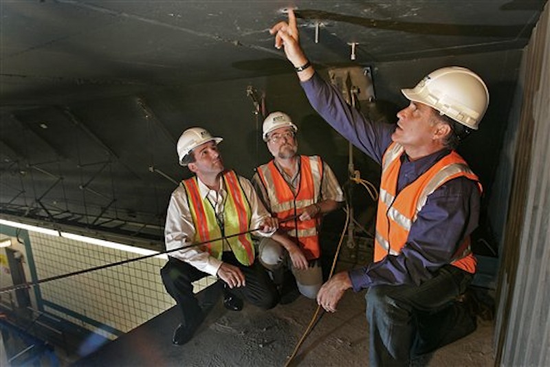 In this July 18, 2006, file photo, Gov. Mitt Romney, right, looks over bolts in the ceiling of a Big Dig tunnel while speaking with Alexander Bardow, center, Massachusetts Director of Bridges and Structures, and Massachusetts Secretary of Transportation John Cogliano in Boston. Romney was at his New Hampshire vacation home on a summer night in 2006 when tons of concrete ceiling panels in one of Bostonís Big Dig highway tunnels collapsed. The debris crushed a car and killed a female passenger. Romney, then in his final year as Massachusetts governor, dashed back to Boston and immersed himself in the crisis. His response offers insights into what kind of leader the expected Republican nominee would be if elected president. Romney has made his management skills a major selling point in his campaign. (AP Photo/David L Ryan, Pool)