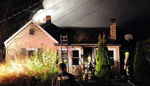 Firefighters battle a blaze on Paul Street in Auburn late Tuesday night. Richard and Bonnie Desjardings escaped the fire uninjured with two of their three dogs, but were looking for the third they hoped made it into the backyard. It was one of two fires in the community Tuesday night.