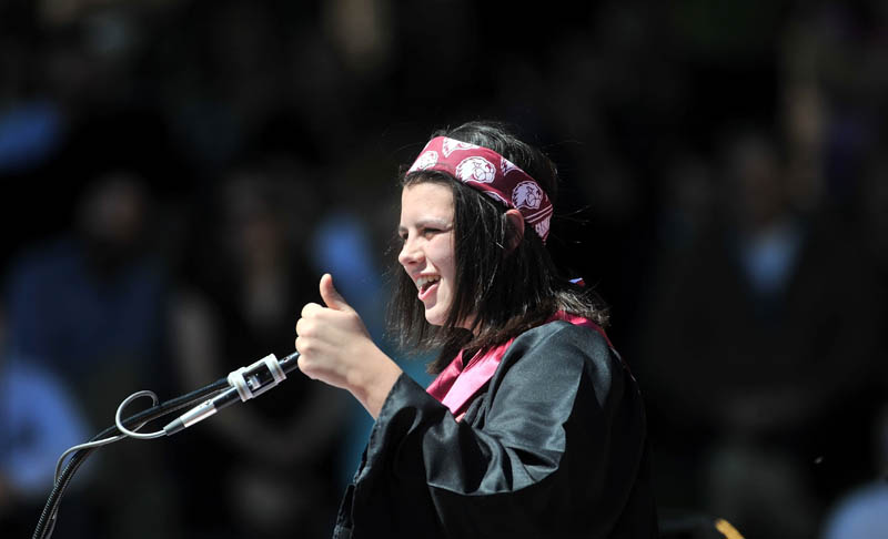 Staff Photo by Michael G. Seamans University of Maine at Farmington Senior Class Speaker, Merissa Beaulieu gives the thumbs-up to classmates after removing her mortor board and replacing it with her signature bandana during Commencement ceremonies at University of Maine at Farmington Saturday.