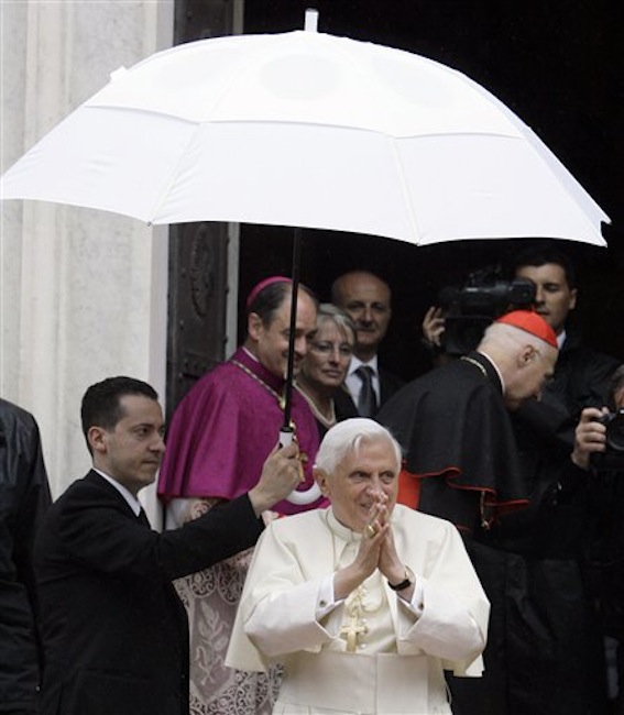 In this May 17, 2008 file photo, Pope Benedict XVI acknowledges faithful upon his arrival at the Our Lady of Mercy Shrine in Savona, near Genoa, Italy. The Vatican has confirmed Saturday, May 26, 2012, that the pope's butler Paolo Gabriele, at left holding the umbrella, was arrested in an embarrassing leaks scandal. Spokesman the Rev. Federico Lombardi said Paolo Gabriele was arrested in his home inside Vatican City with secret documents in his possession. (AP Photo/Luca Bruno, file)