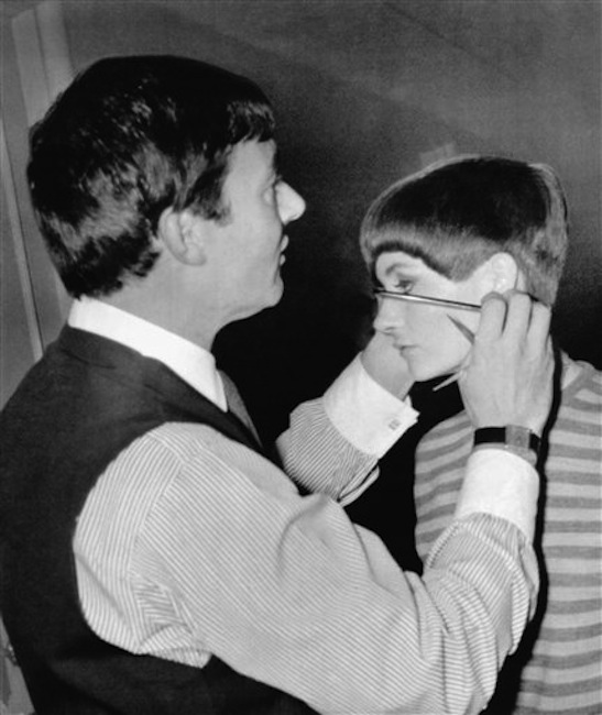 In this Jan. 11, 1966 file photo, hair stylist Vidal Sassoon gives New York model Holly McGuire a close-cropped hairdo at a preview of the New York Couture Group styles in New York. Sassoon, whose 1960s wash-and-wear cuts freed women from endless teasing and hairspray died Wednesday, May 9, 2012, at his home. He was 84. (AP Photo, file) Cutting Standing Expertise Holding Scissors Preparation