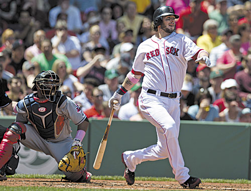WATCH IT FLY: Boston’s Jarrod Saltalamacchia watches his two-run single off Cleveland’s Justin Masterson during the first inning Sunday at Fenway Park in Boston. Indians catcher Carlos Santana is at left. Saltalamacchia finished 3 for 4 with a home run and five RBIs.