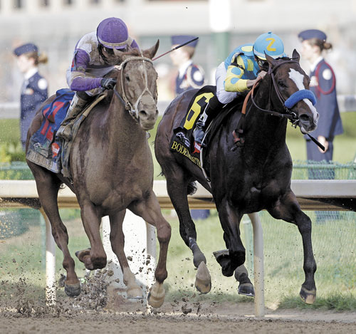 TO THE FINISH: Jockey Mario Gutierrez rides I’ll Have Another, left, past Bodemeister, ridden by Mike Smith (6), to victory in the 138th Kentucky Derby on Saturday at Churchill Downs in Louisville, Ky.