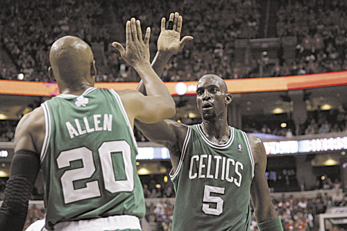 WAY TO GO: Boston’s Kevin Garnett high-fives teammate Ray Allen during the first half of Game 3 of an NBA Eastern Conference semifinal playoff series against the Philadelphia 76ers on Wednesday in Philadelphia. Garnett, who turns 36 on Saturday, made 12 of 17 shots in Game 3 and is shooting 63 percent overall in the series.
