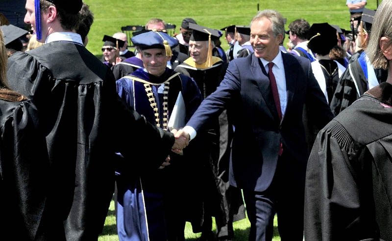 THANKS: Former Prime Minister of Britain Tony Blair shakes hands with a Colby College graduate after Blairr gave the commencerment address on Sunday. College President William Adams is left of Blair.