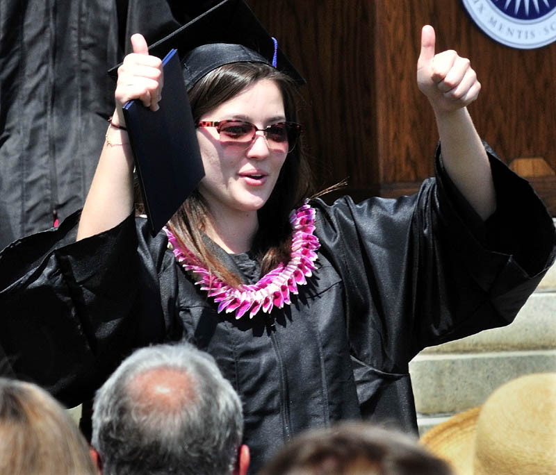 YEAH: Colby College senior Tate Kaneshige holds her diploma and gives a thumbs-up to relatives during commencement on Sunday.