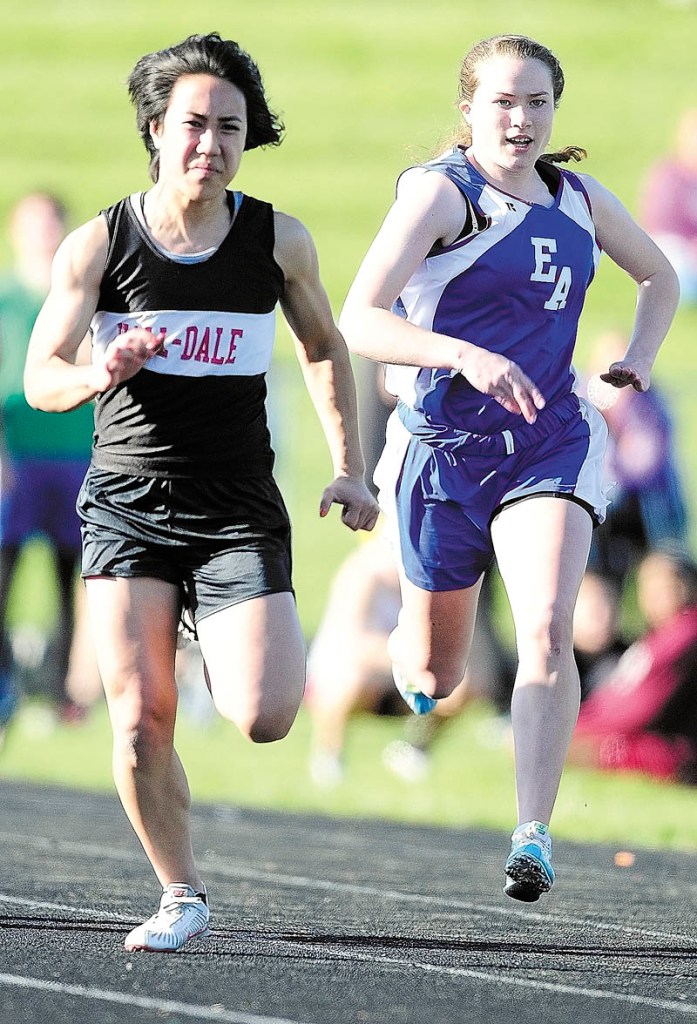 TRIFECTA: Hall-Dale’s Bri Crisci, left, leads Erskine Academy’s Jade Canak in 100 meter dash during the Capital City Classic last week at Alumni Field in Augusta. Crisci won in 12.83, her fastest time of the season. She also won the 200 and the 400.